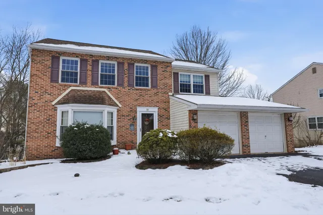 a view of a house with a yard and garage