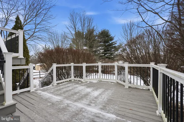 a view of a house with a wooden deck