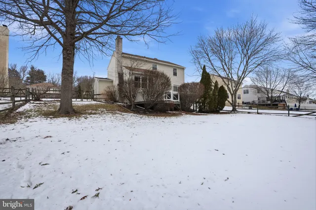 a view of a yard covered with snow in the road