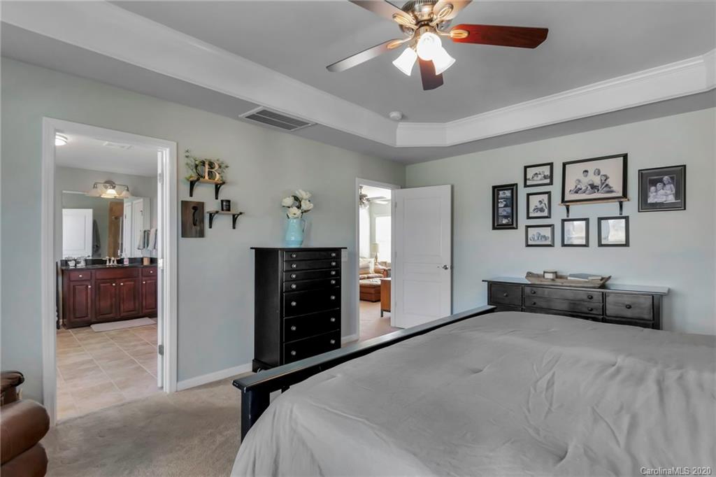 1521 Ridgehaven Road Waxhaw, NC 28173 - Photo 13 of 29 a bedroom with a bed and a chandelier