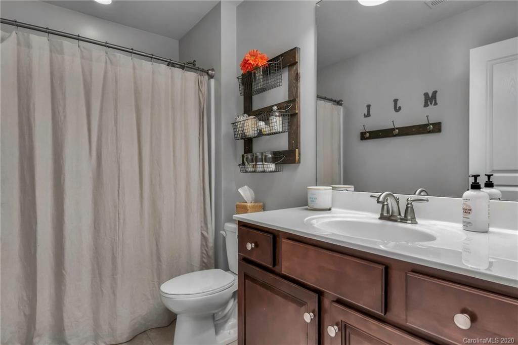 1521 Ridgehaven Road Waxhaw, NC 28173 - Photo 17 of 29 a bathroom with a granite countertop sink and a mirror
