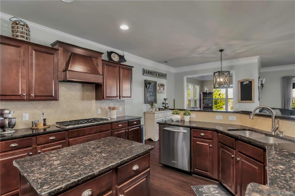 1521 Ridgehaven Road Waxhaw, NC 28173 - Photo 4 of 29 a kitchen with stainless steel appliances granite countertop a sink stove and cabinets