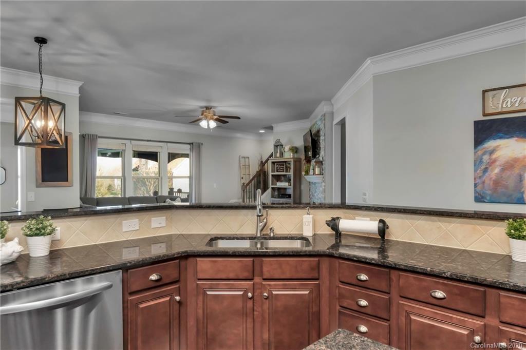 1521 Ridgehaven Road Waxhaw, NC 28173 - Photo 6 of 29 a kitchen with granite countertop a sink and cabinets