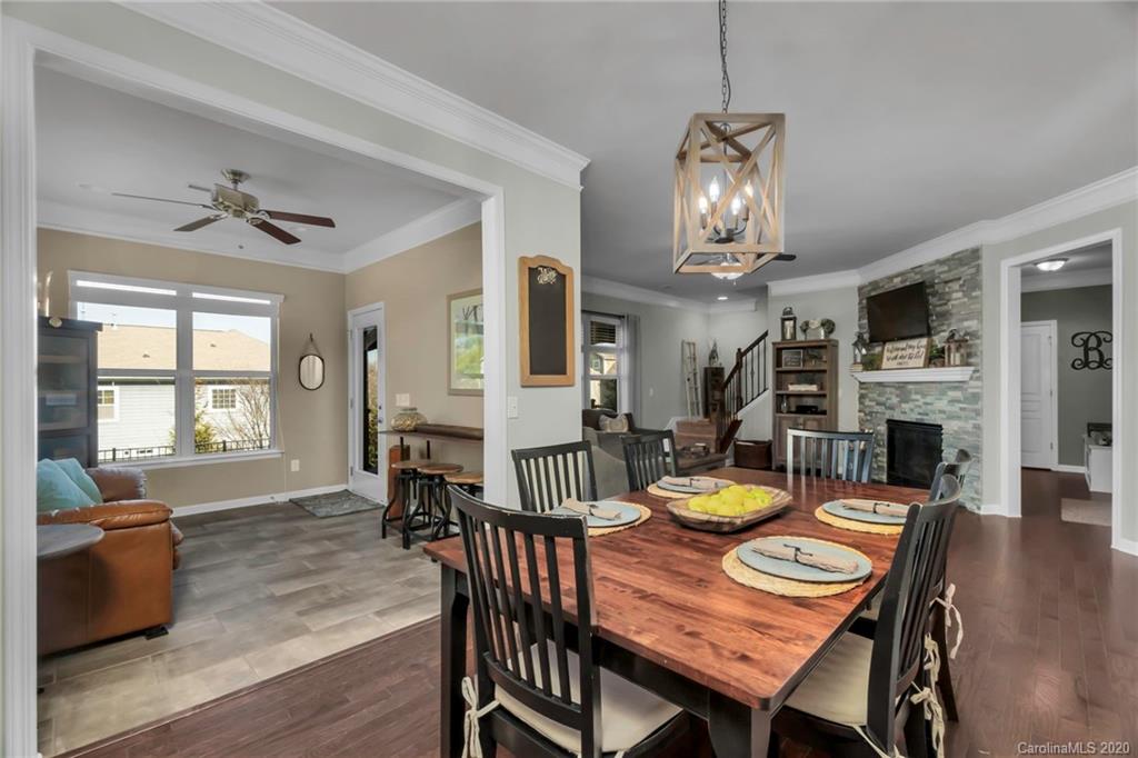 1521 Ridgehaven Road Waxhaw, NC 28173 - Photo 8 of 29 a view of a dining room with furniture a chandelier and wooden floor