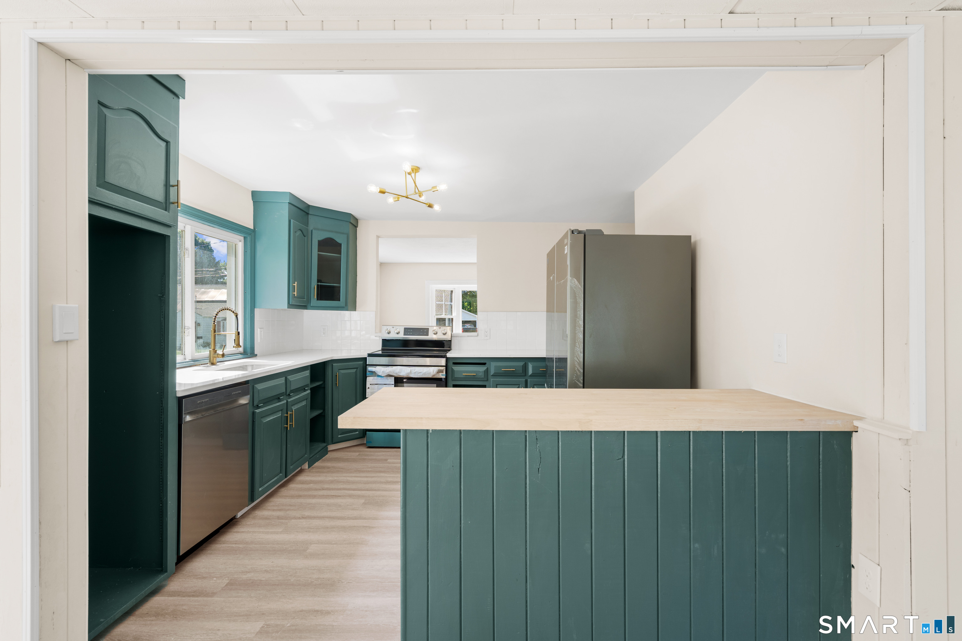 175 Moody Street Bristol, CT 06010 - Photo 13 of 28 a large kitchen with cabinets and stainless steel appliances