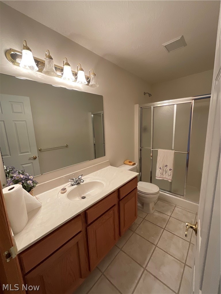 8603 Murray Road Cleveland, OH 44125 - Photo 13 of 26 Bathroom with an enclosed shower, vanity, tile floors, and toilet
