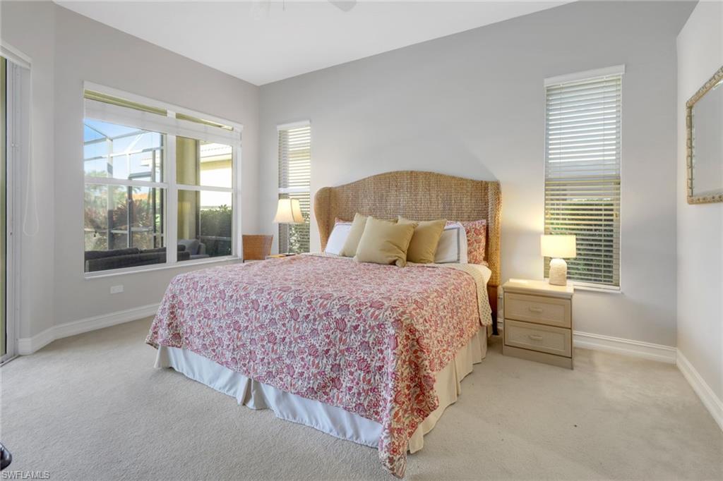 6757 Bent Grass Drive Naples, FL 34113 - Photo 12 of 27 a bedroom with a bed and a large window