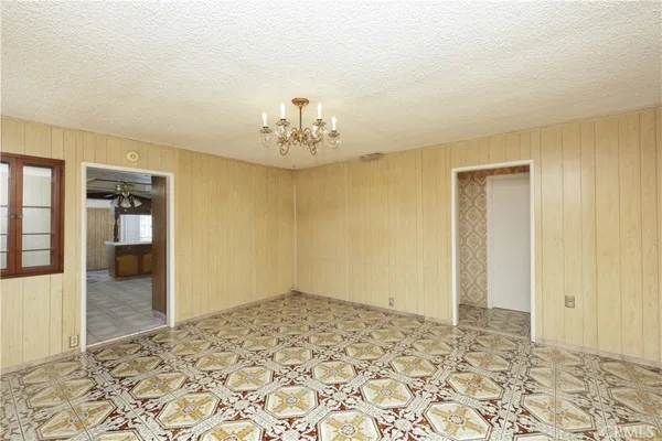 a view of a livingroom with wooden floor and a bathroom space