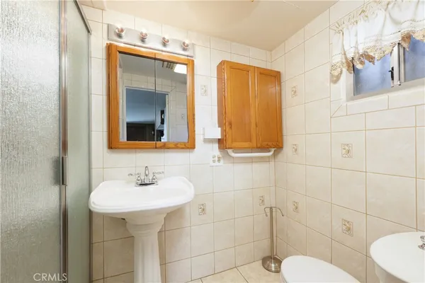 a bathroom with a sink toilet and mirror