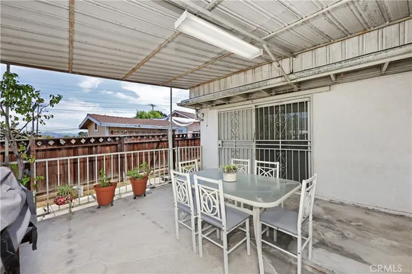 a dining room with furniture and outdoor kitchen