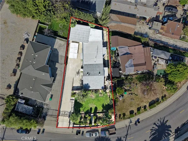 an aerial view of multiple houses with a yard