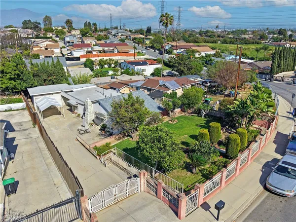 an aerial view of multiple houses with a yard