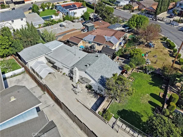 an aerial view of residential houses with outdoor space