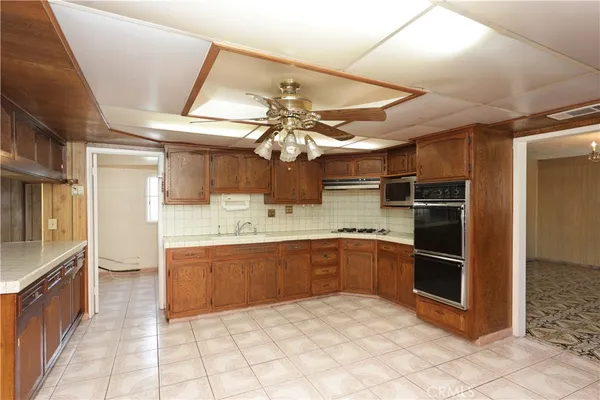 a kitchen with stainless steel appliances granite countertop a sink and cabinets