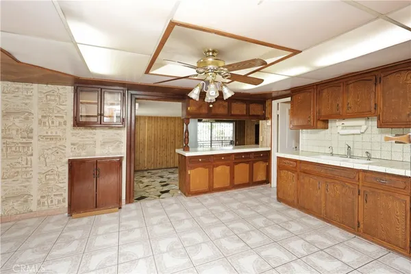a kitchen with a cabinets and chandelier