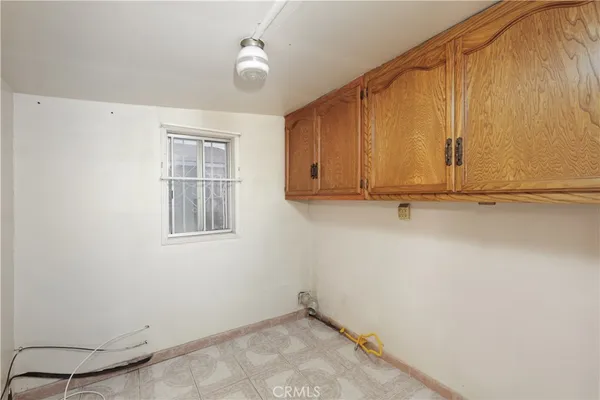 a view of storage and utility room with window
