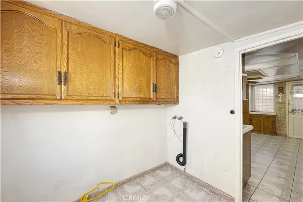 a view of a storage & utility room with a sink