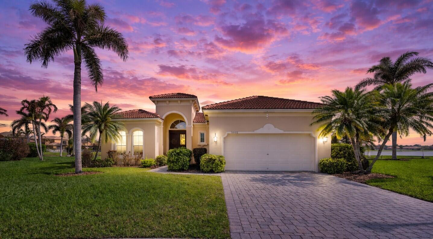 5902 Walnut Park Lane Fort Pierce, FL 34951 - Photo 1 of 45 a front view of a house with a garden and a yard