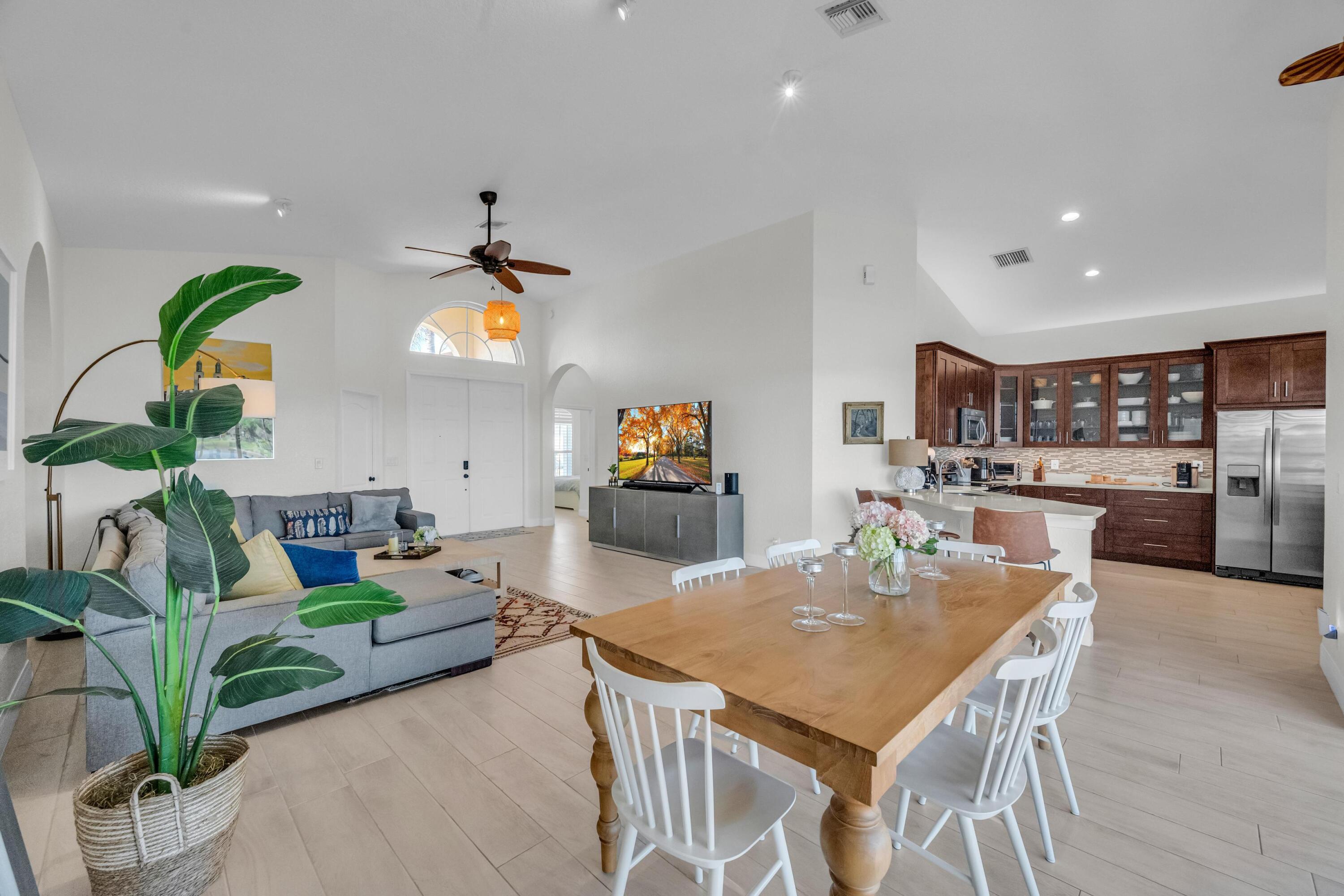 5902 Walnut Park Lane Fort Pierce, FL 34951 - Photo 11 of 45 a living room with kitchen island furniture and a chandelier