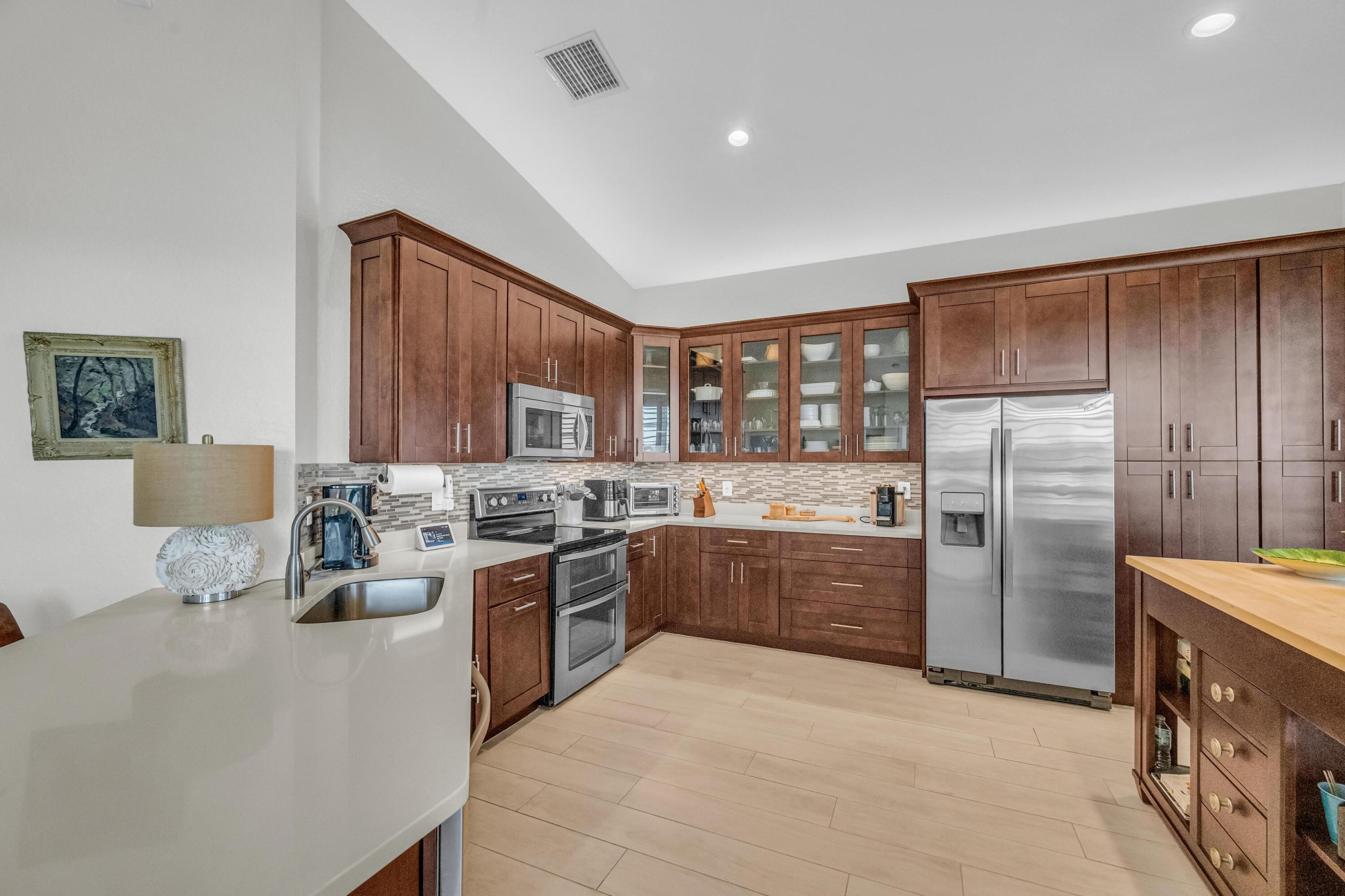 5902 Walnut Park Lane Fort Pierce, FL 34951 - Photo 12 of 45 a kitchen with cabinets and stainless steel appliances