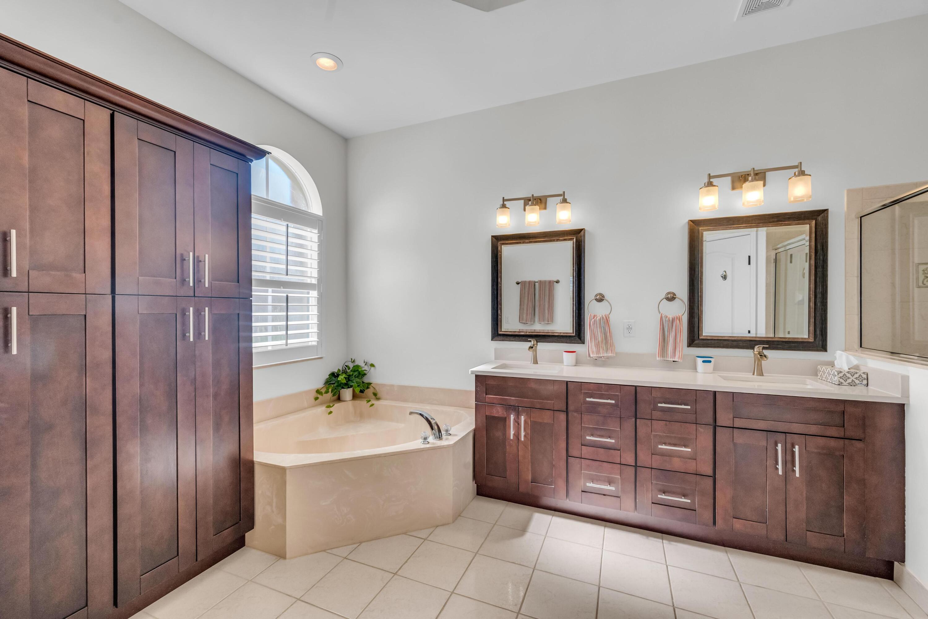 5902 Walnut Park Lane Fort Pierce, FL 34951 - Photo 20 of 45 a spacious bathroom with a double vanity sink and a mirror