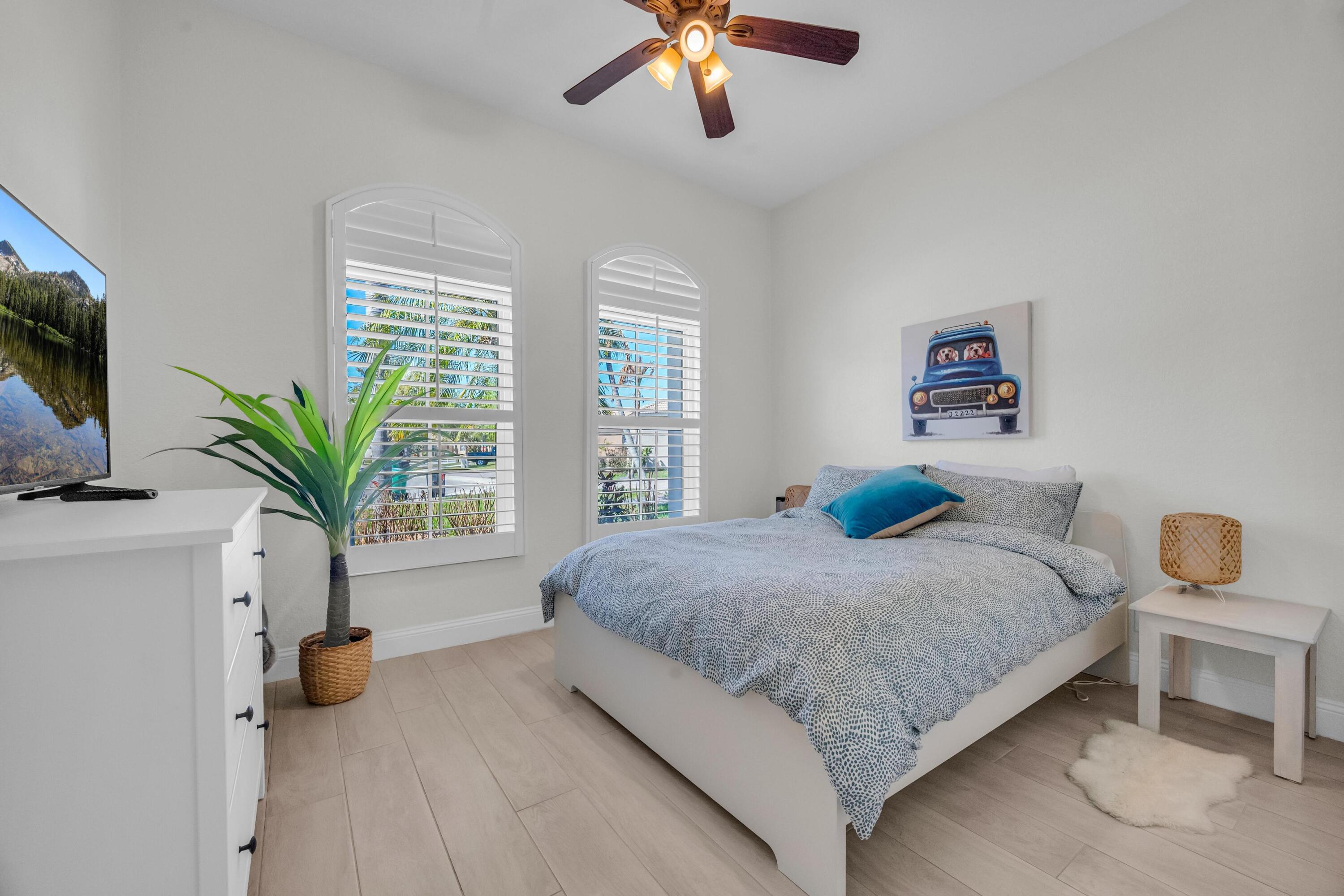 5902 Walnut Park Lane Fort Pierce, FL 34951 - Photo 22 of 45 a bedroom with a bed and a potted plant