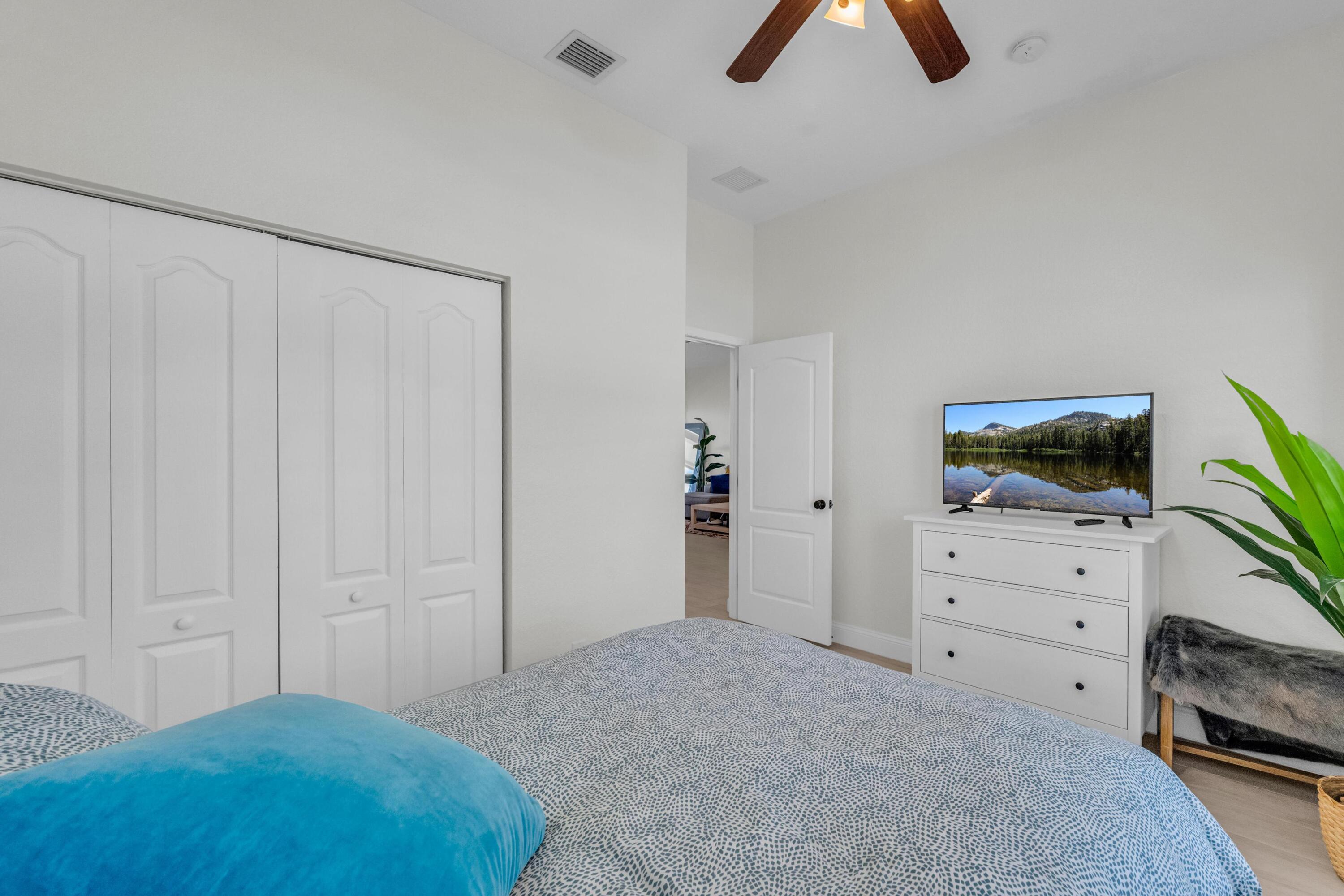 5902 Walnut Park Lane Fort Pierce, FL 34951 - Photo 23 of 45 a bedroom with a bed and a tv on the dresser