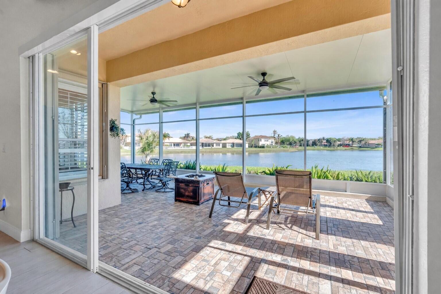 5902 Walnut Park Lane Fort Pierce, FL 34951 - Photo 27 of 45 a living room with a floor to ceiling window and an outdoor view