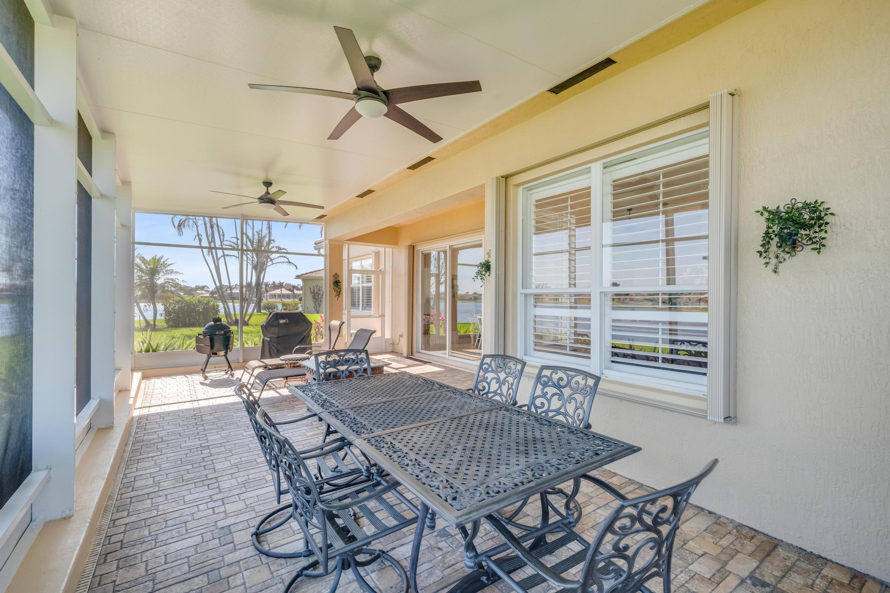 5902 Walnut Park Lane Fort Pierce, FL 34951 - Photo 31 of 45 a dining room with furniture a chandelier and wooden floor