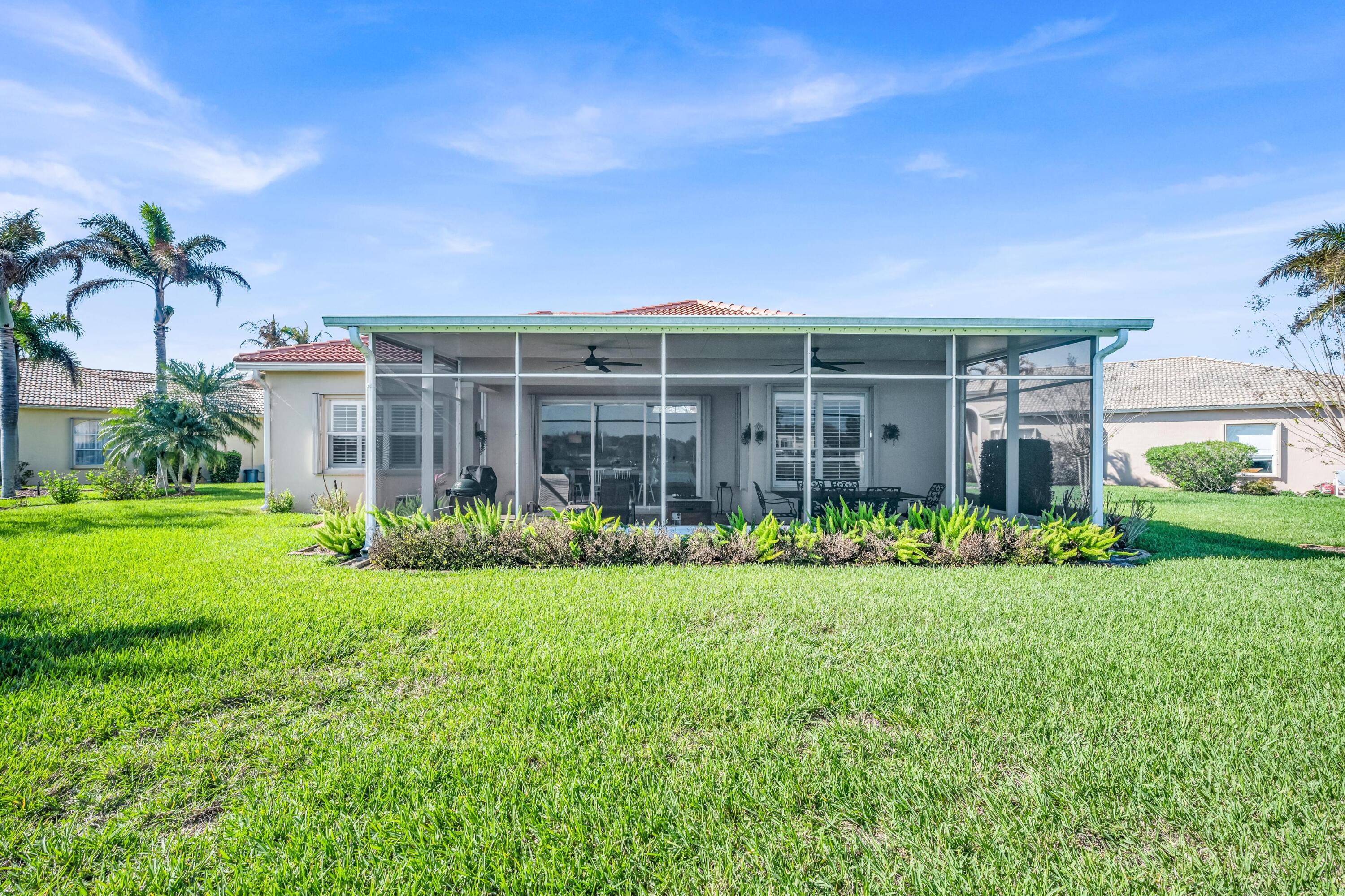 5902 Walnut Park Lane Fort Pierce, FL 34951 - Photo 33 of 45 a view of a house with a big yard and large trees