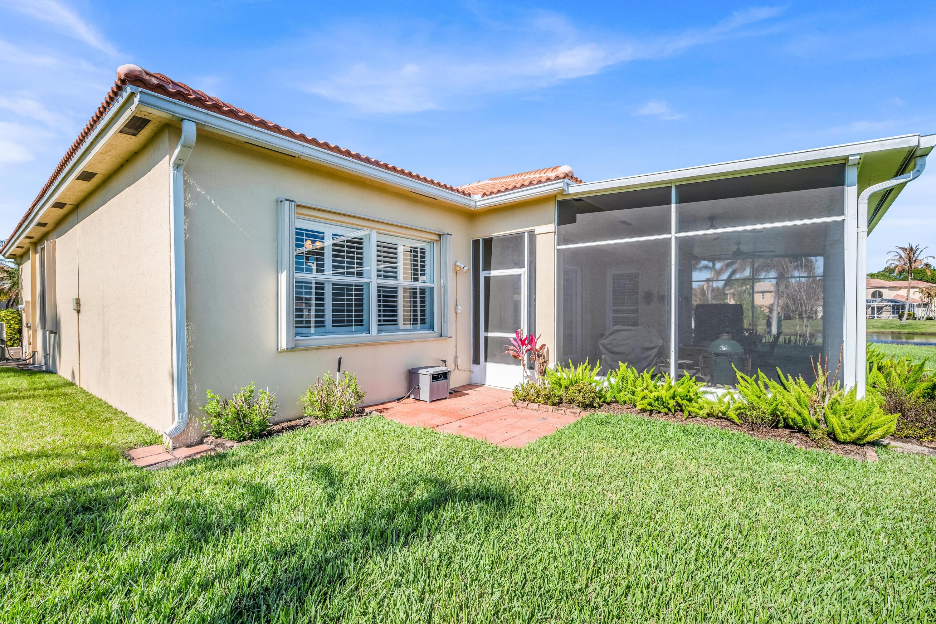 5902 Walnut Park Lane Fort Pierce, FL 34951 - Photo 36 of 45 a front view of a house with garden