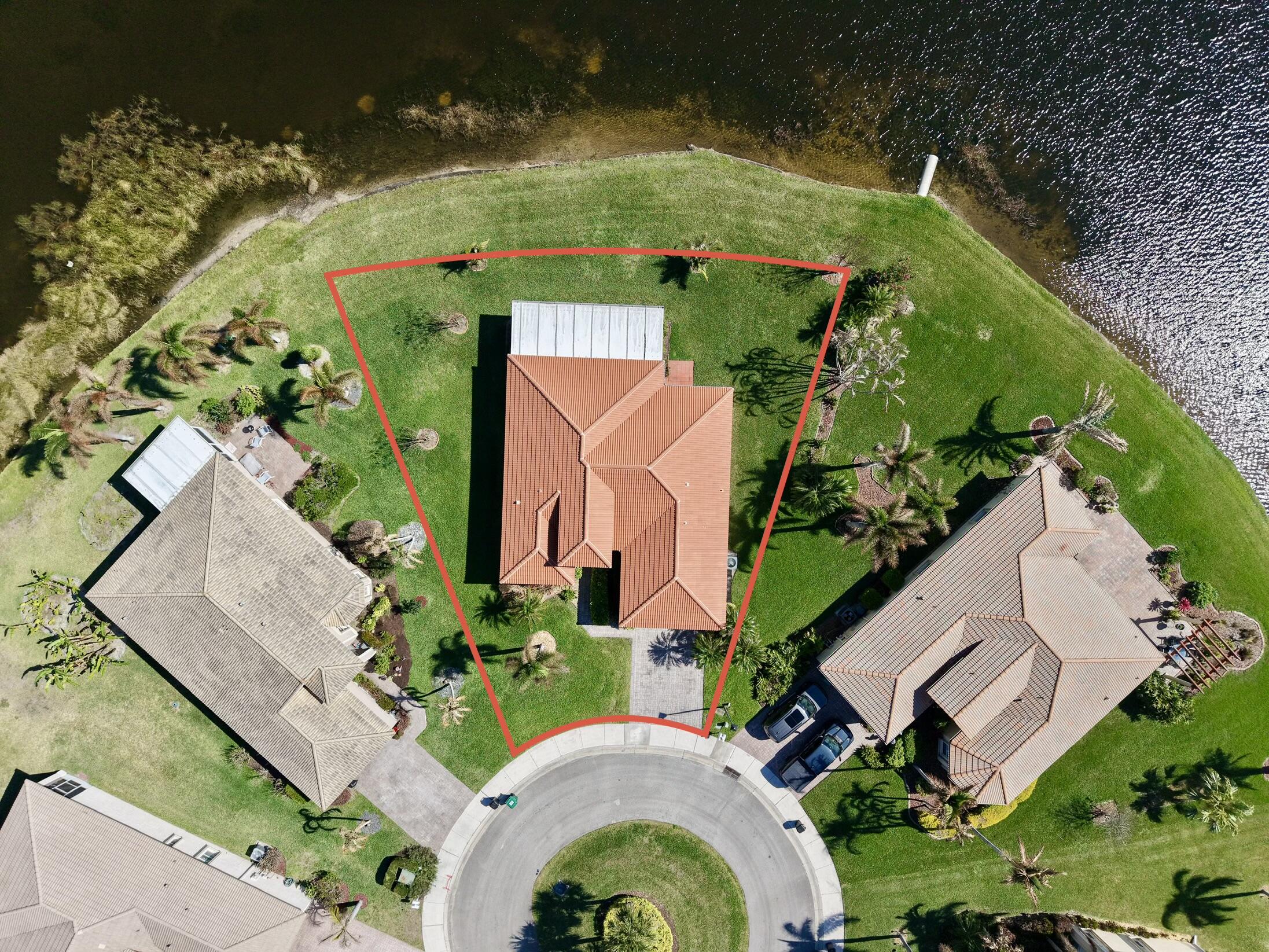 5902 Walnut Park Lane Fort Pierce, FL 34951 - Photo 4 of 45 an aerial view of a house with a yard and a lake view