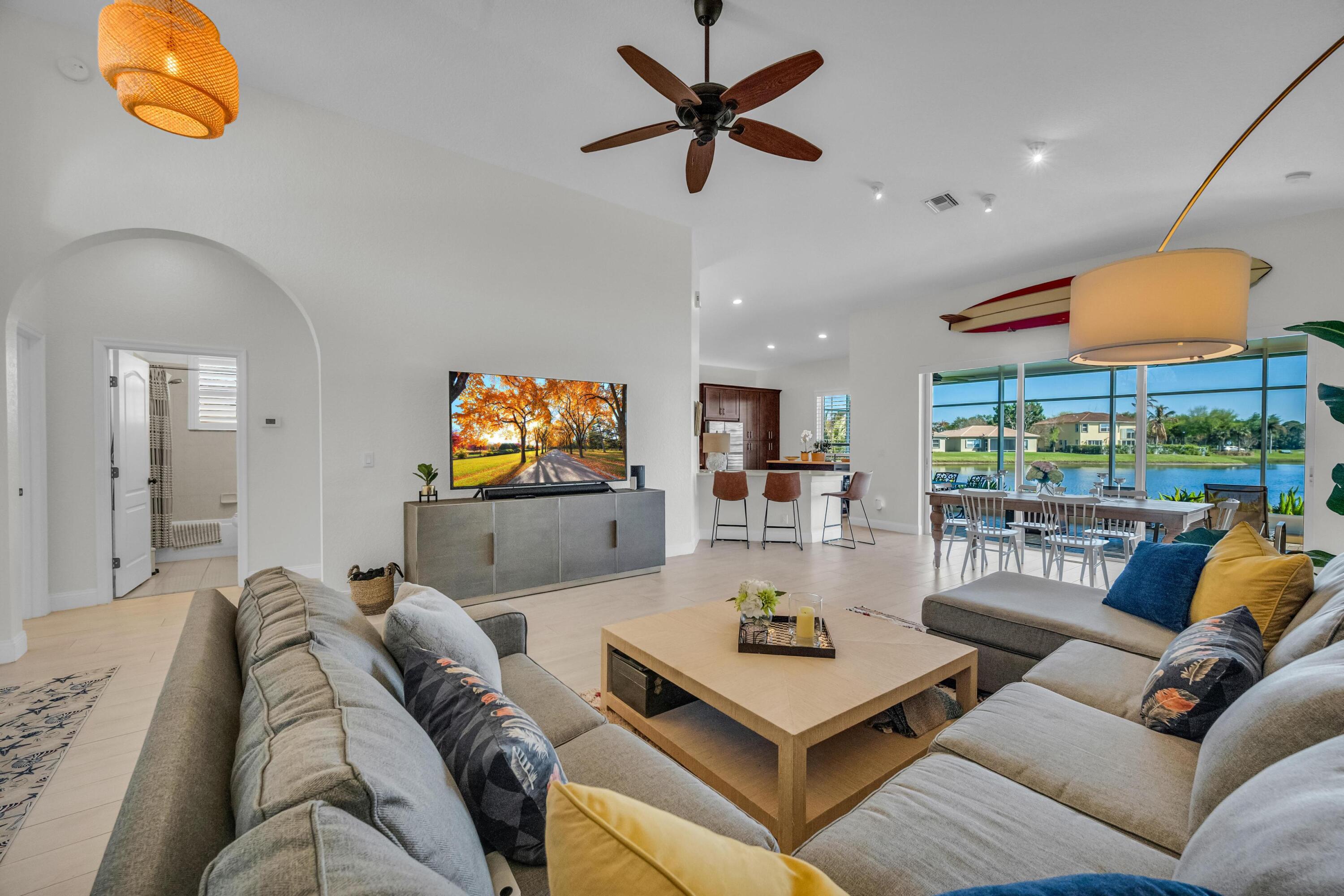 5902 Walnut Park Lane Fort Pierce, FL 34951 - Photo 9 of 45 a living room with furniture and a floor to ceiling window