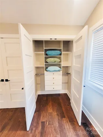 a view of walk in closet with empty racks