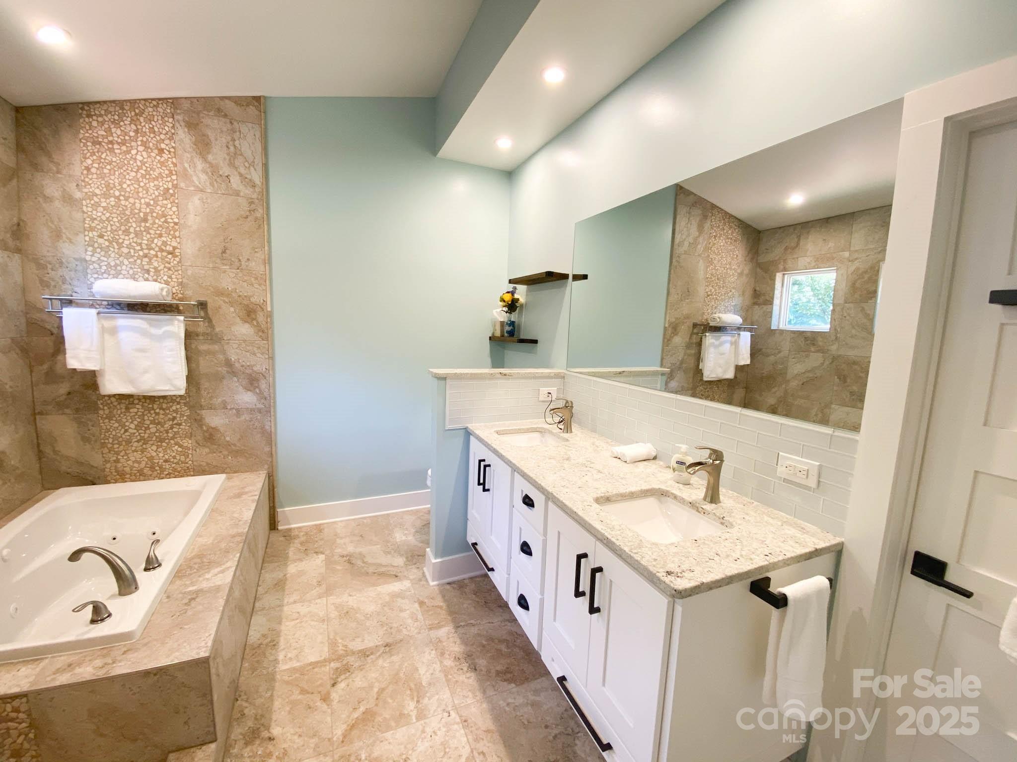 141 Carnegie Road Rutherfordton, NC 28139 - Photo 14 of 48 a spacious bathroom with a bathtub sink and mirror