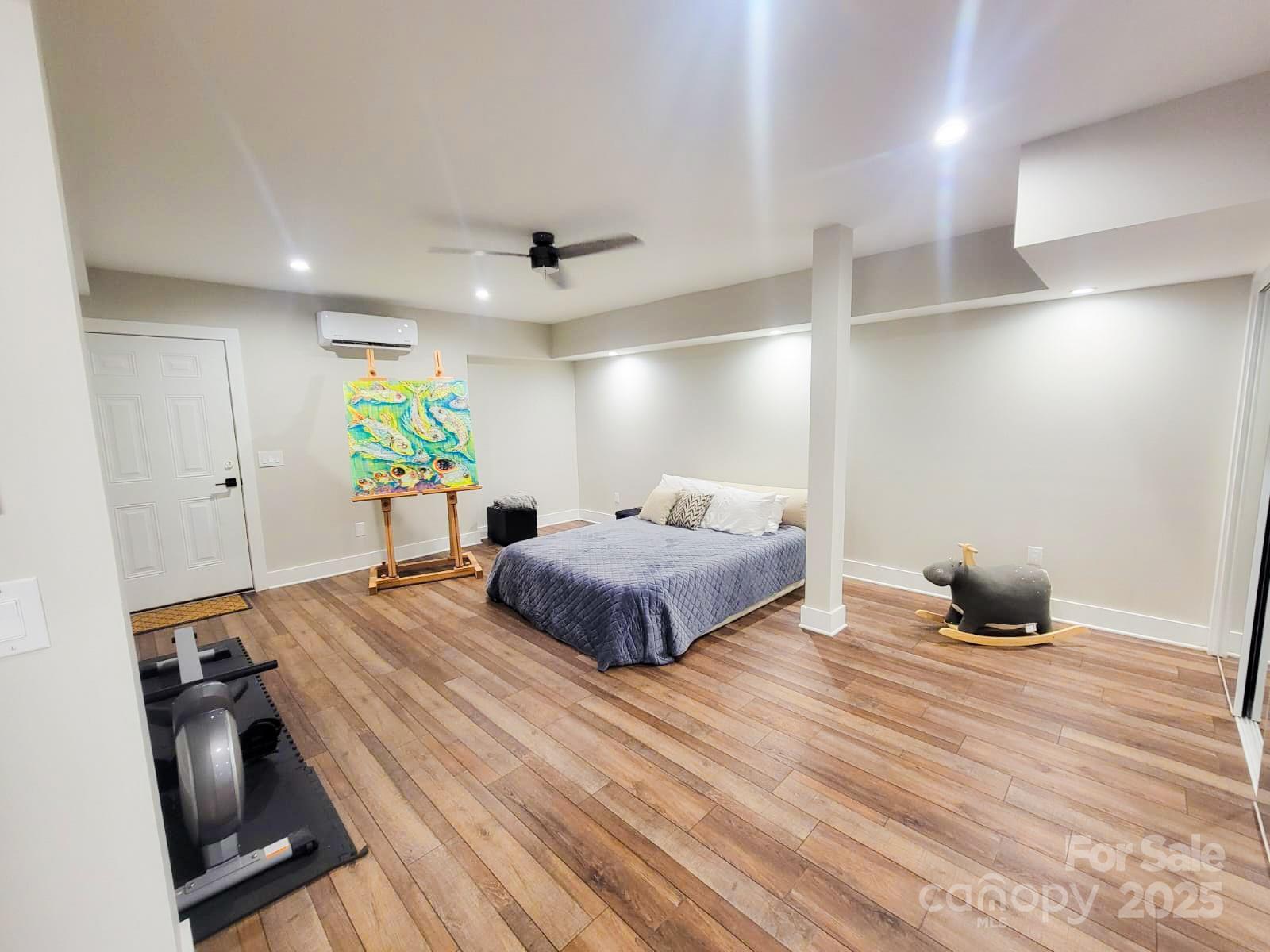 141 Carnegie Road Rutherfordton, NC 28139 - Photo 26 of 48 a large bedroom with a bed and wooden floor