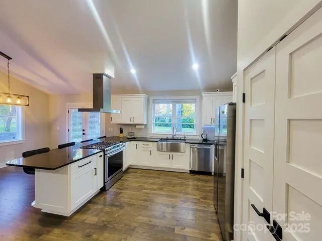 a kitchen with a stove a refrigerator and a sink