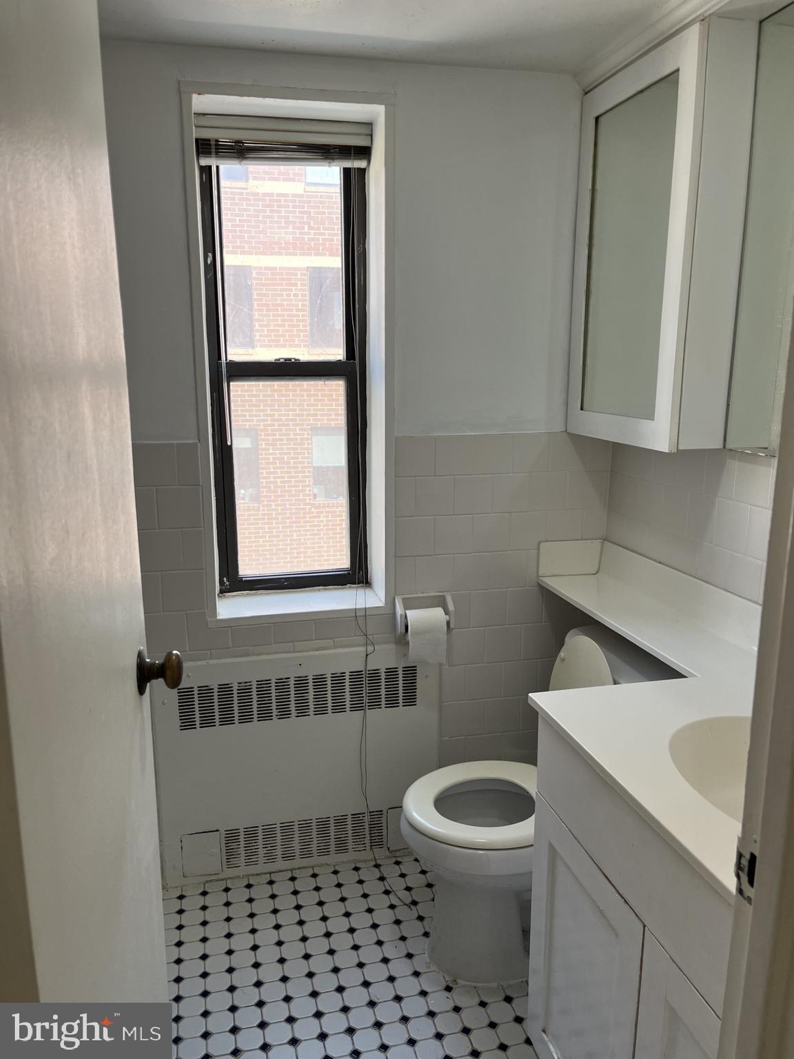 522 21st Street Northwest, Unit 811 Washington, DC 20006 - Photo 21 of 23 a bathroom with a toilet a window and a shower