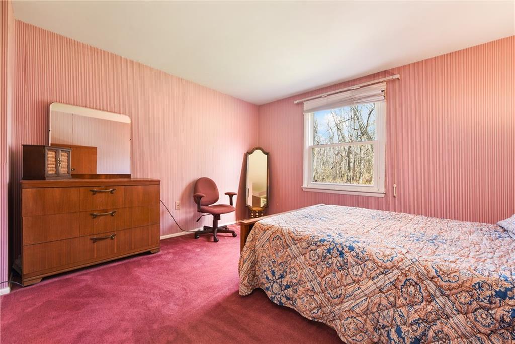 159 Pinehurst Drive Freedom, PA 15042 - Photo 23 of 33 a bedroom with a bed and a dresser with mirror