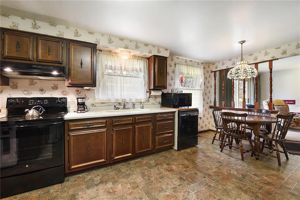 159 Pinehurst Drive Freedom, PA 15042 - Photo 7 of 33 a kitchen with a stove top oven sink and cabinets