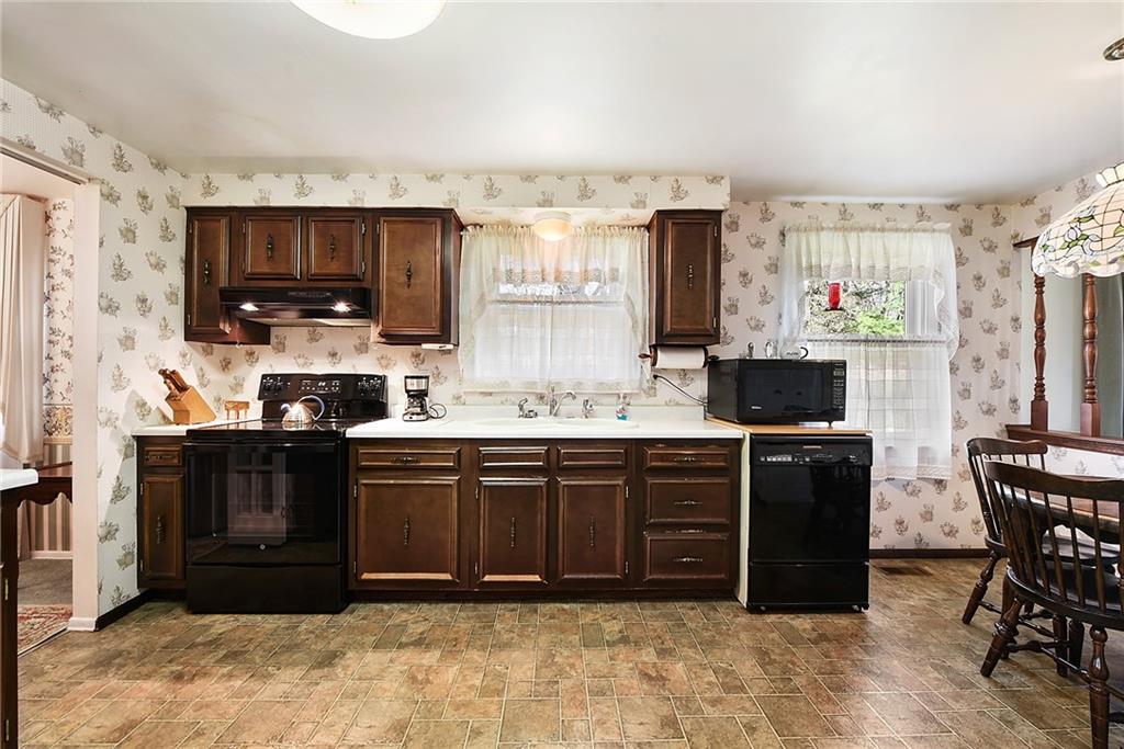 159 Pinehurst Drive Freedom, PA 15042 - Photo 8 of 33 a kitchen with stainless steel appliances granite countertop a refrigerator stove top oven a sink and dishwasher