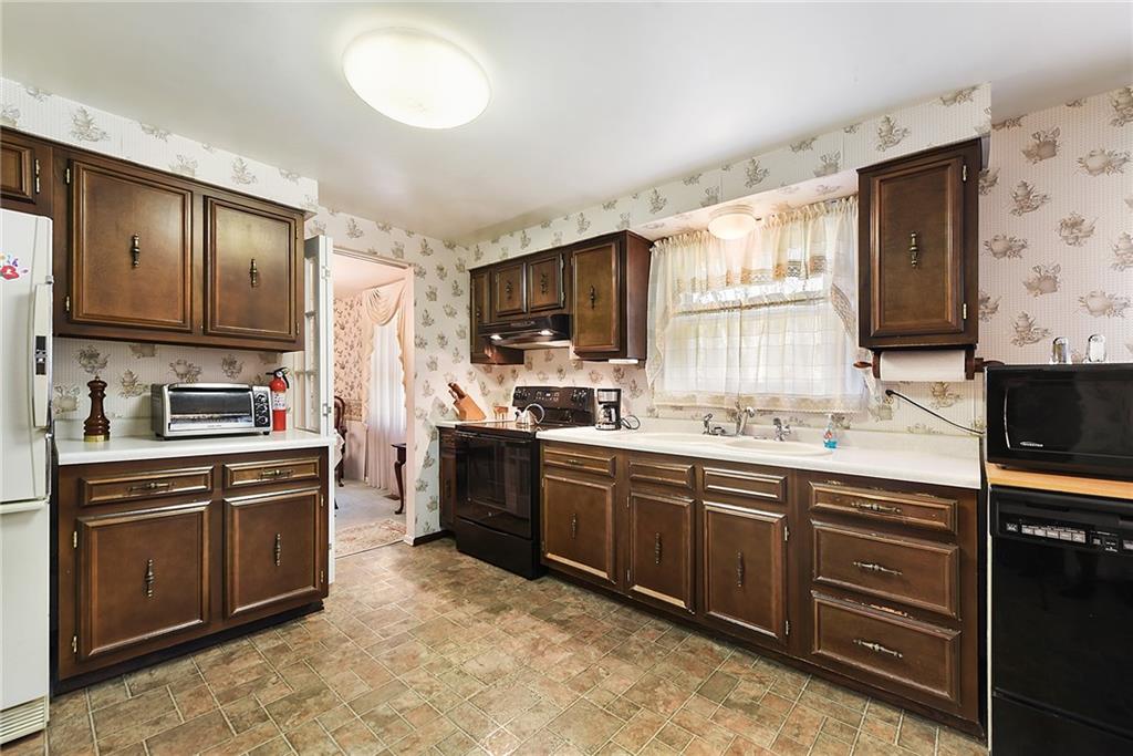 159 Pinehurst Drive Freedom, PA 15042 - Photo 9 of 33 a kitchen with stainless steel appliances granite countertop a stove sink and cabinets