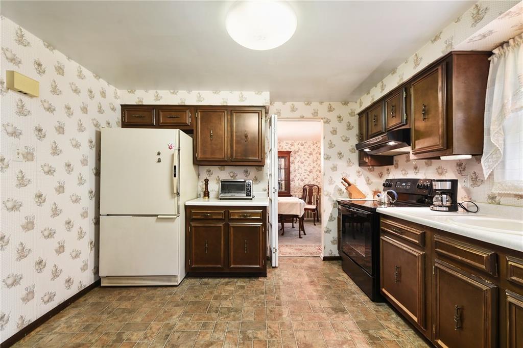 159 Pinehurst Drive Freedom, PA 15042 - Photo 10 of 33 a kitchen with a refrigerator a stove top oven a sink and dishwasher