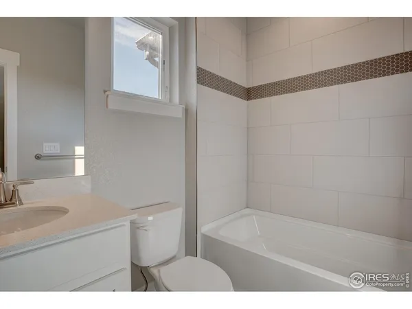 a bathroom with a sink a toilet a vanity and mirror