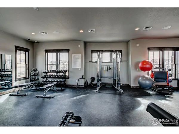 a room with gym equipment and a large window