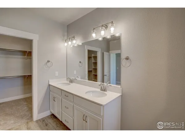 a bathroom with a double vanity sink and a mirror