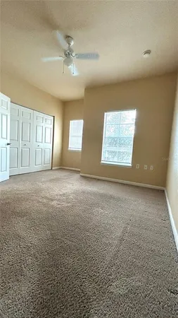 an empty room with a empty space and windows