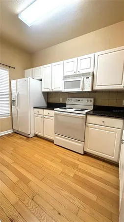 a kitchen with stainless steel appliances a stove a microwave and a refrigerator