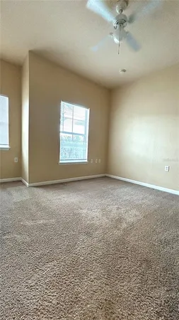 an empty room with a empty space and windows