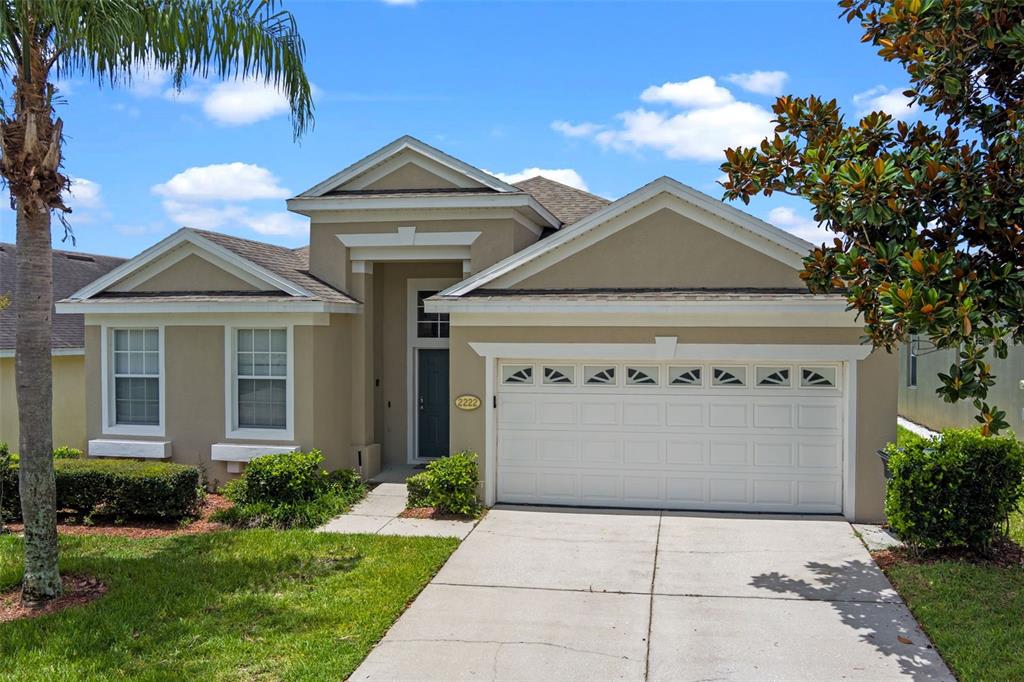 2222 Wyndham Palms Way Kissimmee, FL 34747 - Photo 1 of 1 a front view of a house with a garden